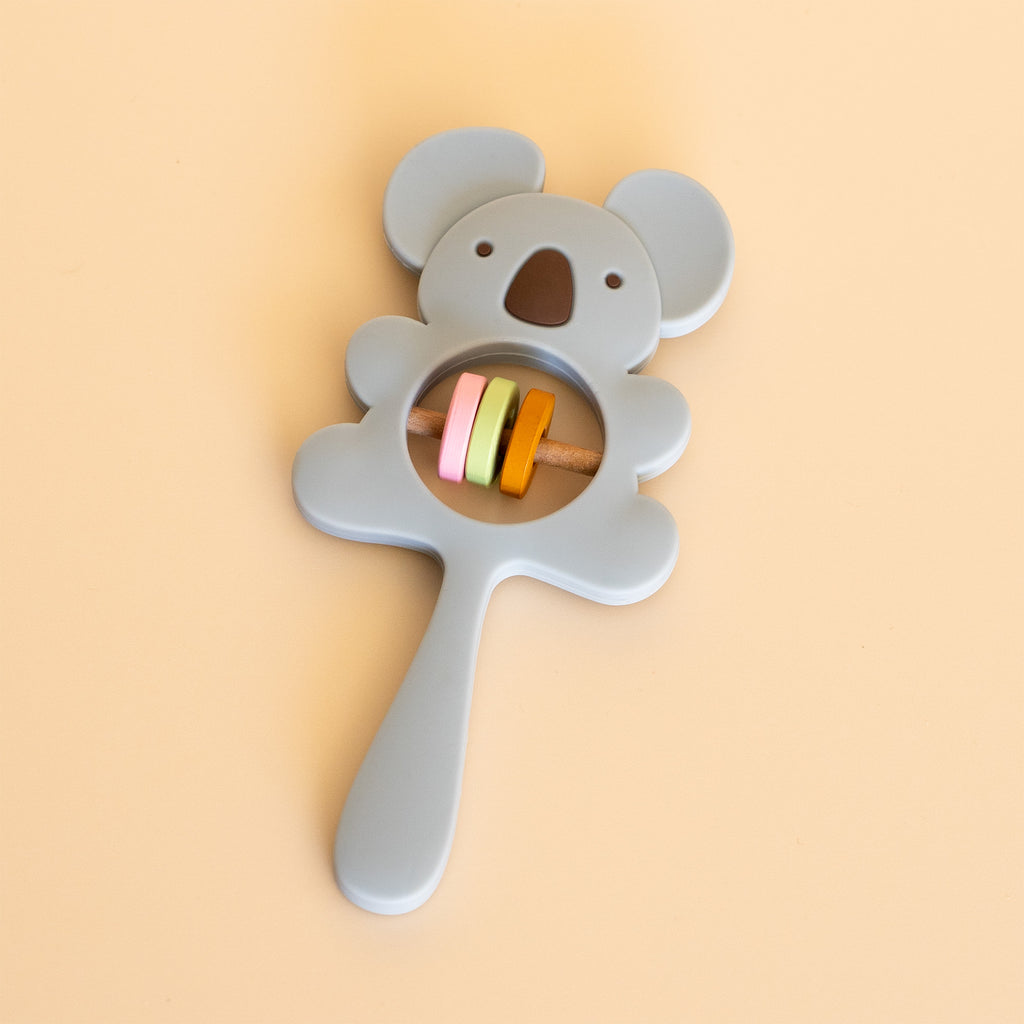 A baby rattle toy shaped like a koala, side view