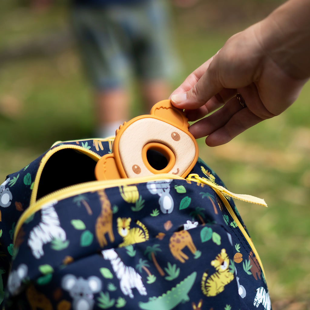 A baby teether like a koalas head, bamboo and silicon, inside kids backpack view