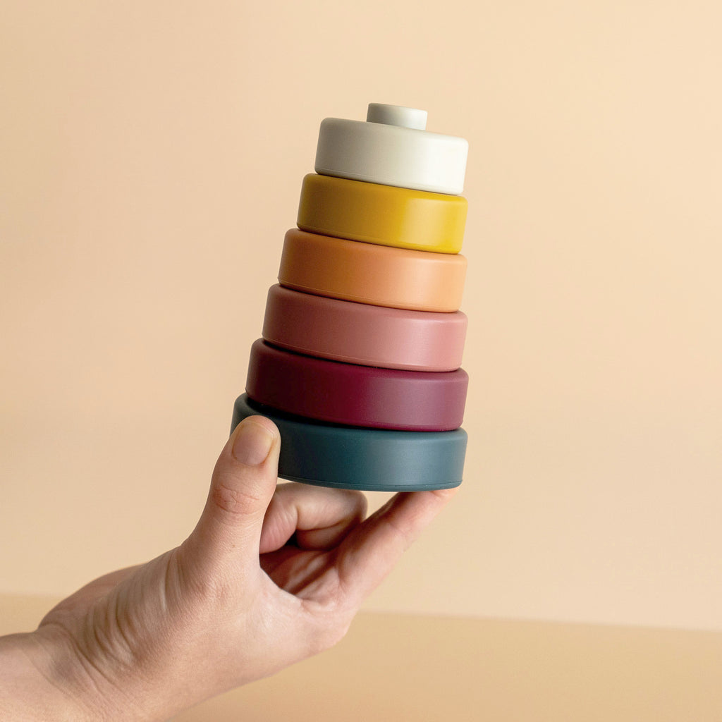 Silicon stacker discs toy for toddlers, held by hand view